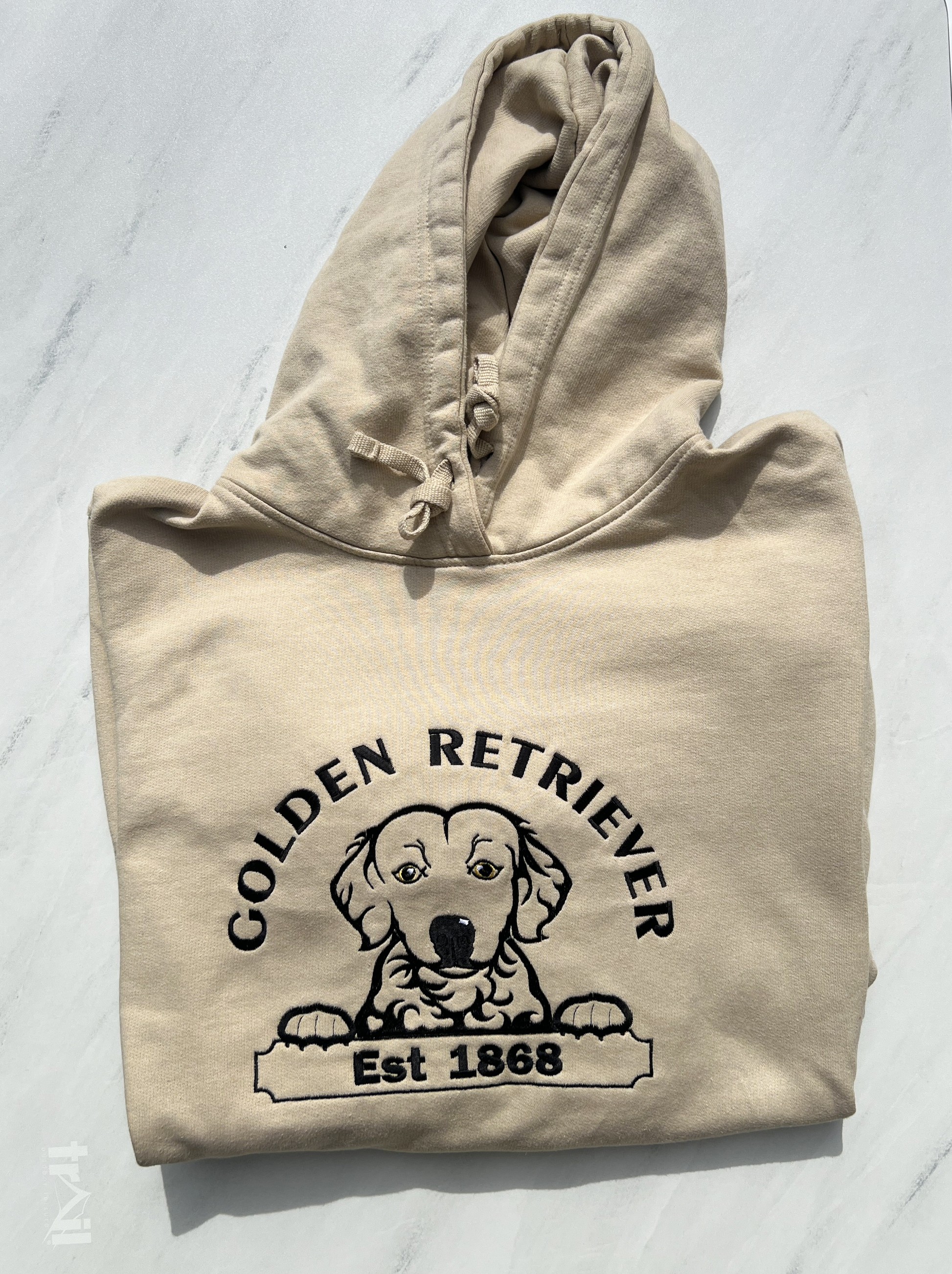 Beige hoodie with Golden Retriever graphic and text on a light gray background